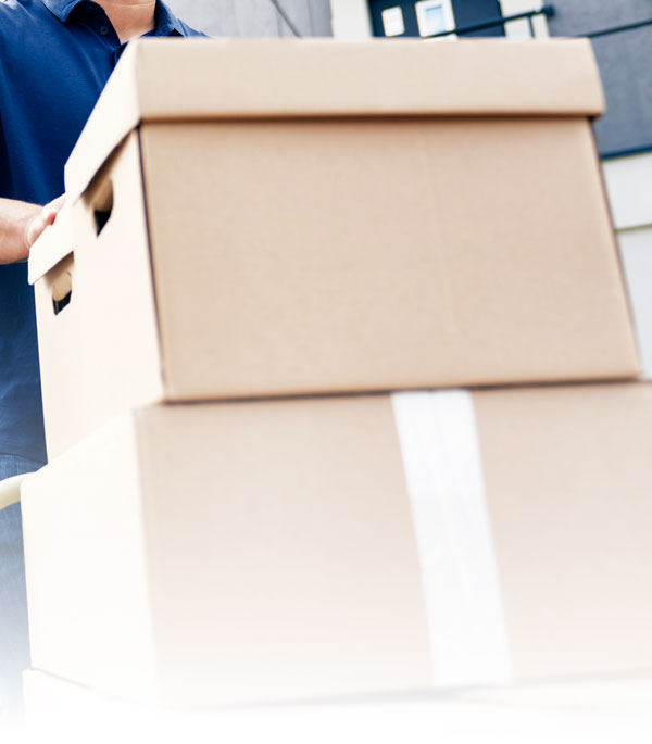 Professional mover carrying stacked cardboard boxes for long distance moving services