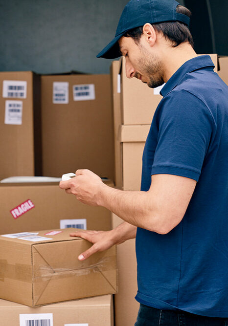 Professional mover scanning inventory boxes inside a moving truck in Ann Arbor