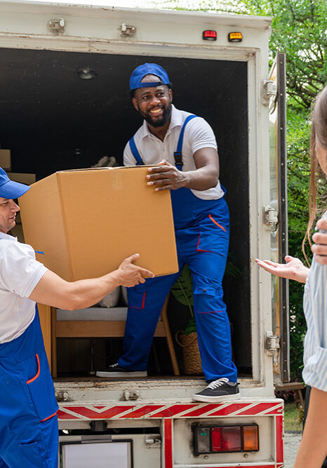 Smith & Sons Moving unloading a box from a moving truck for clients in Farmington Hills