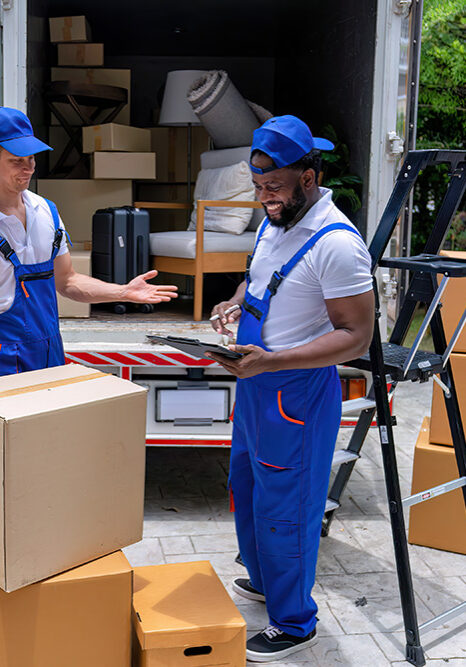 Professional movers reviewing an inventory checklist at the back of a truck in Novi, MI